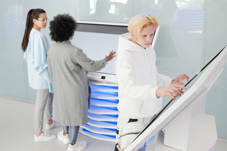 A person's silhouette is seen from behind, interacting with a large, glowing screen displaying abstract data visualizations, symbolizing advanced skills like AI and data literacy.